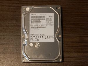 Top lid of a Hitachi HDS721050CLA662 hard drive with the Hitachi logo.